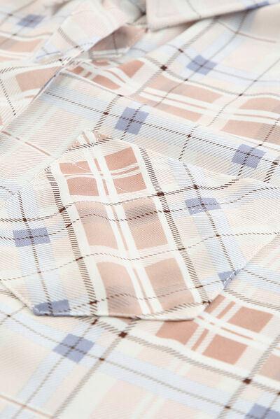 a close up of a shirt with a plaid pattern
