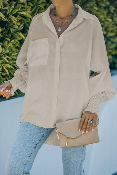 a woman wearing a beige shirt and jeans