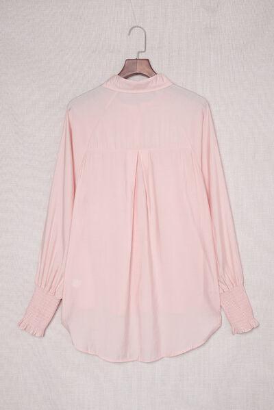 a pink shirt hanging on a hanger