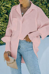 a woman wearing a pink shirt and jeans