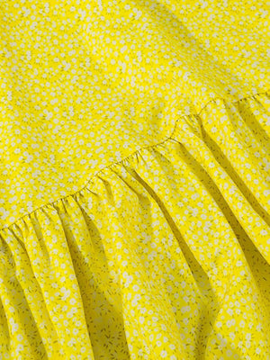 a yellow dress with white flowers on it