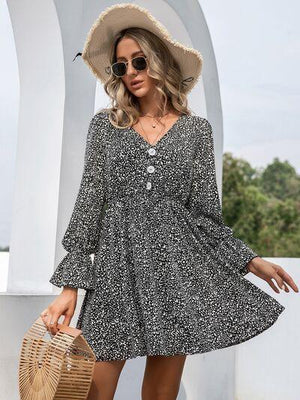 a woman wearing a black and white dress and hat