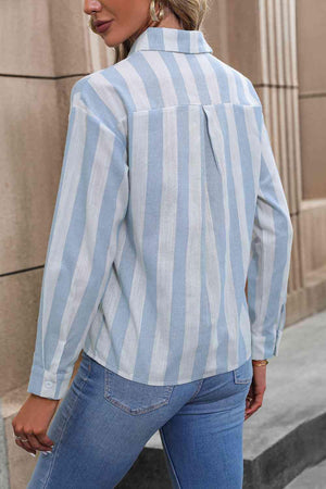 a woman wearing a blue and white striped shirt