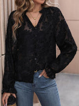 a woman wearing a black blouse and jeans