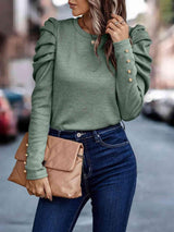 a woman wearing a green sweater and jeans