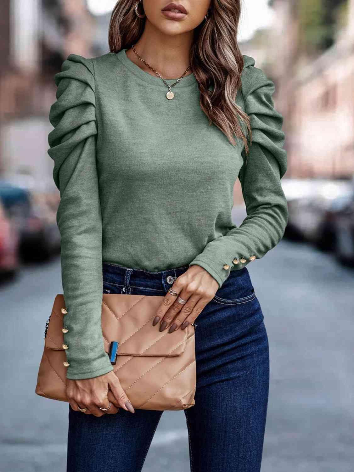 a woman wearing a green sweater and jeans