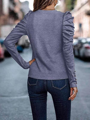 a woman standing on a street with her back to the camera