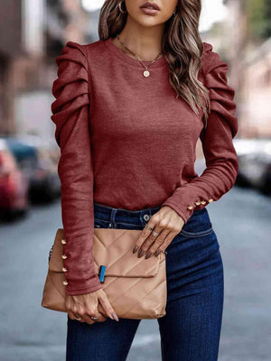 a woman wearing a red sweater and jeans