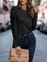 a woman wearing a black top and jeans