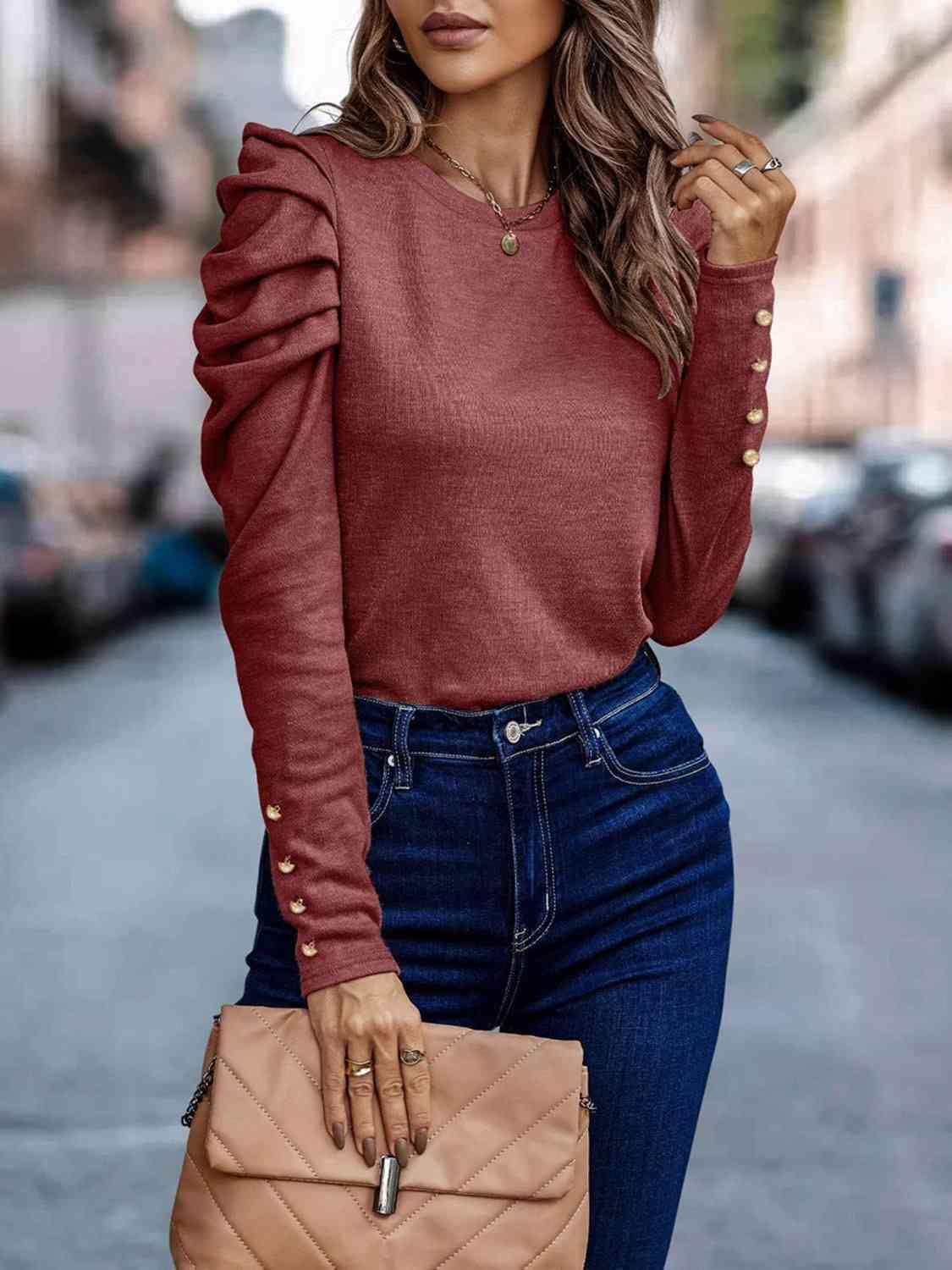 a woman wearing a red sweater and jeans