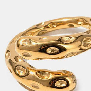 a close up of a gold ring on a white background