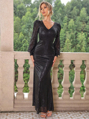 a woman standing on a balcony in a black dress