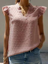 a woman wearing a pink blouse and jeans