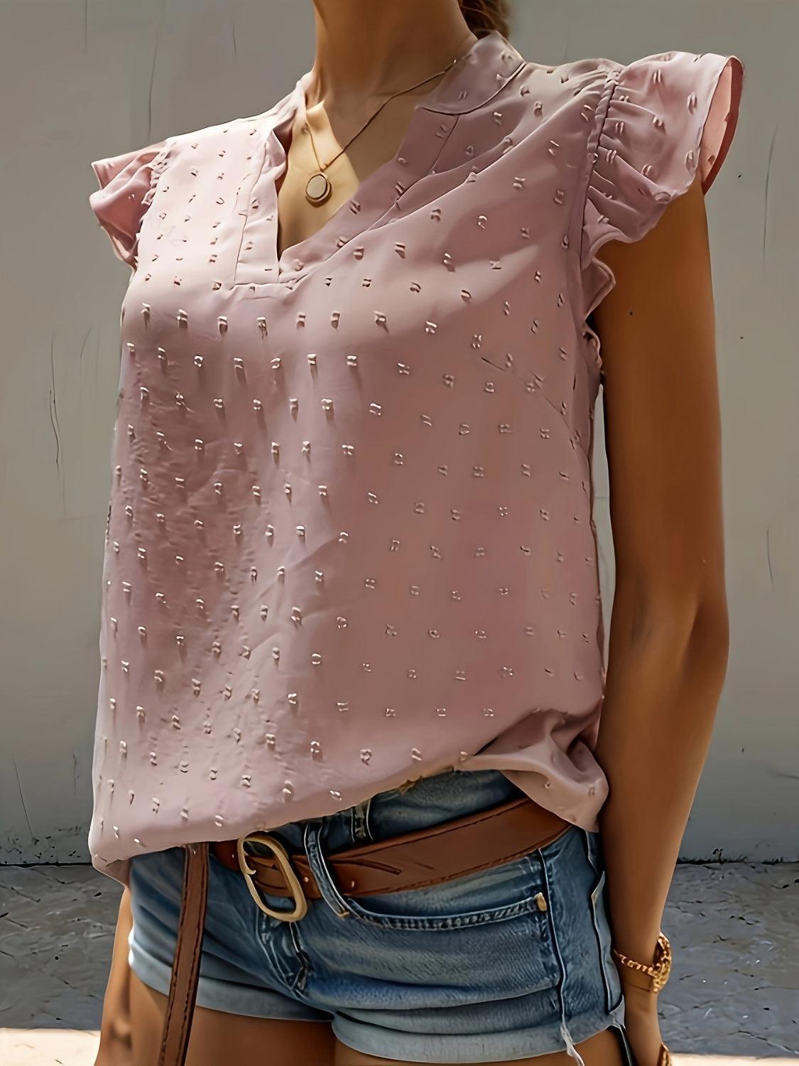a mannequin wearing a pink blouse and denim shorts