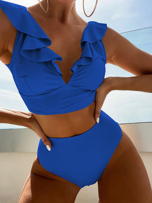 a woman in a blue swimsuit posing for a picture