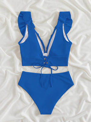 a blue and white swimsuit on a white sheet