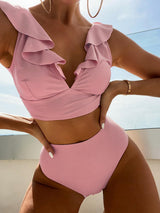 a woman in a pink bikinisuit posing for a picture