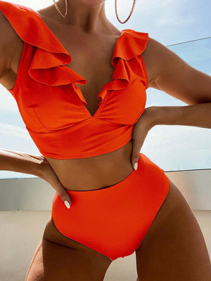 a woman in an orange swimsuit posing for a picture