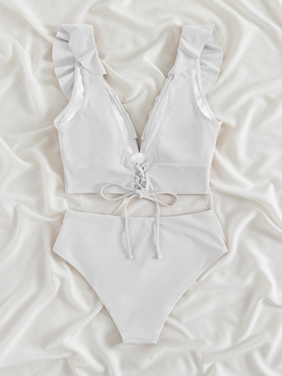 a white bikinisuit with a bow on the side