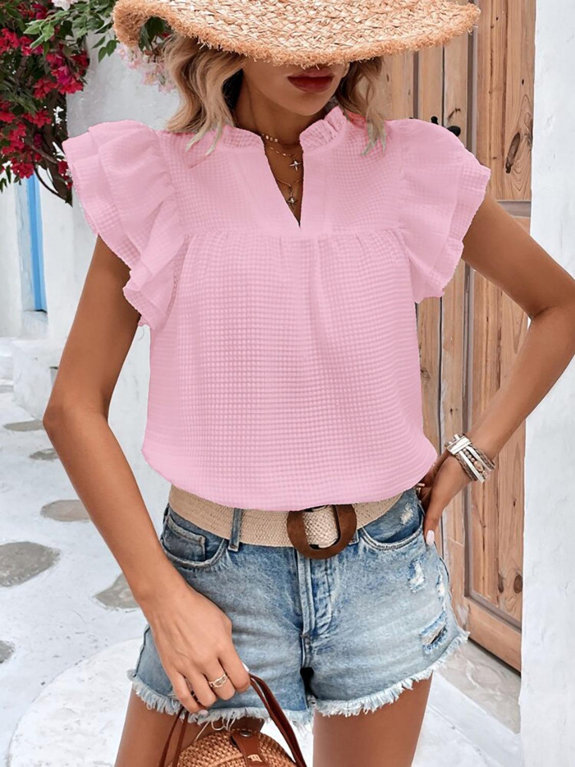 a woman wearing a straw hat and denim shorts