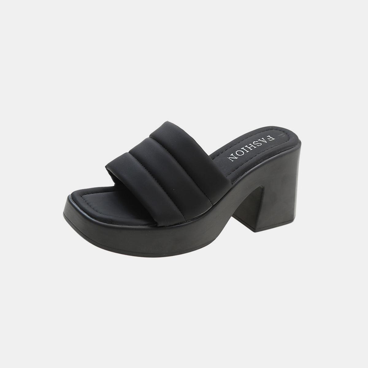 a woman's black platformed sandal with an open toe