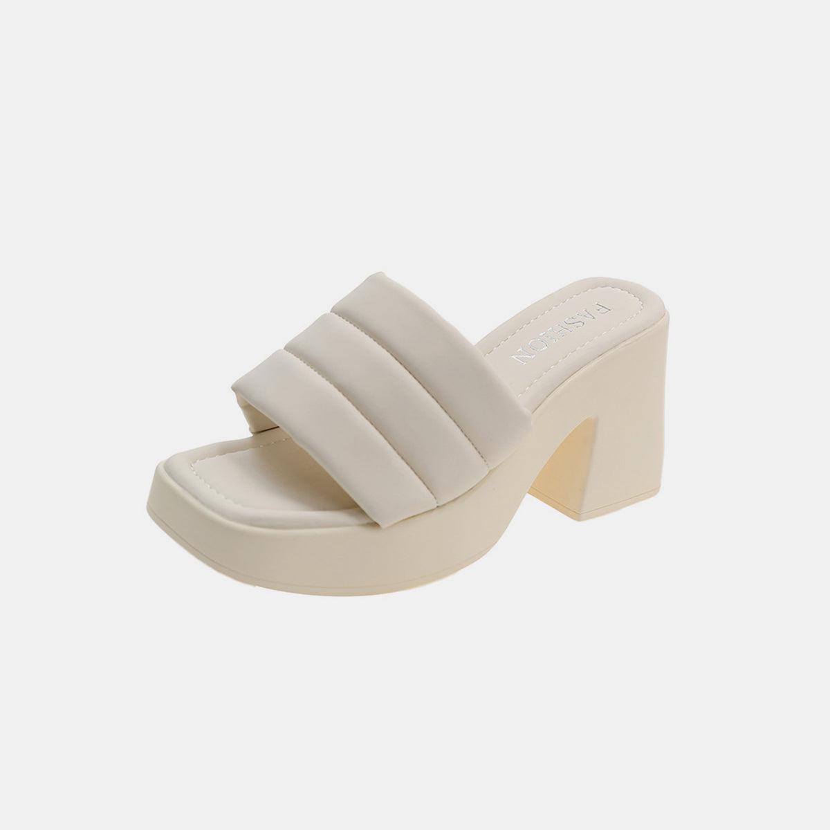 a woman's white shoe with a chunky heel