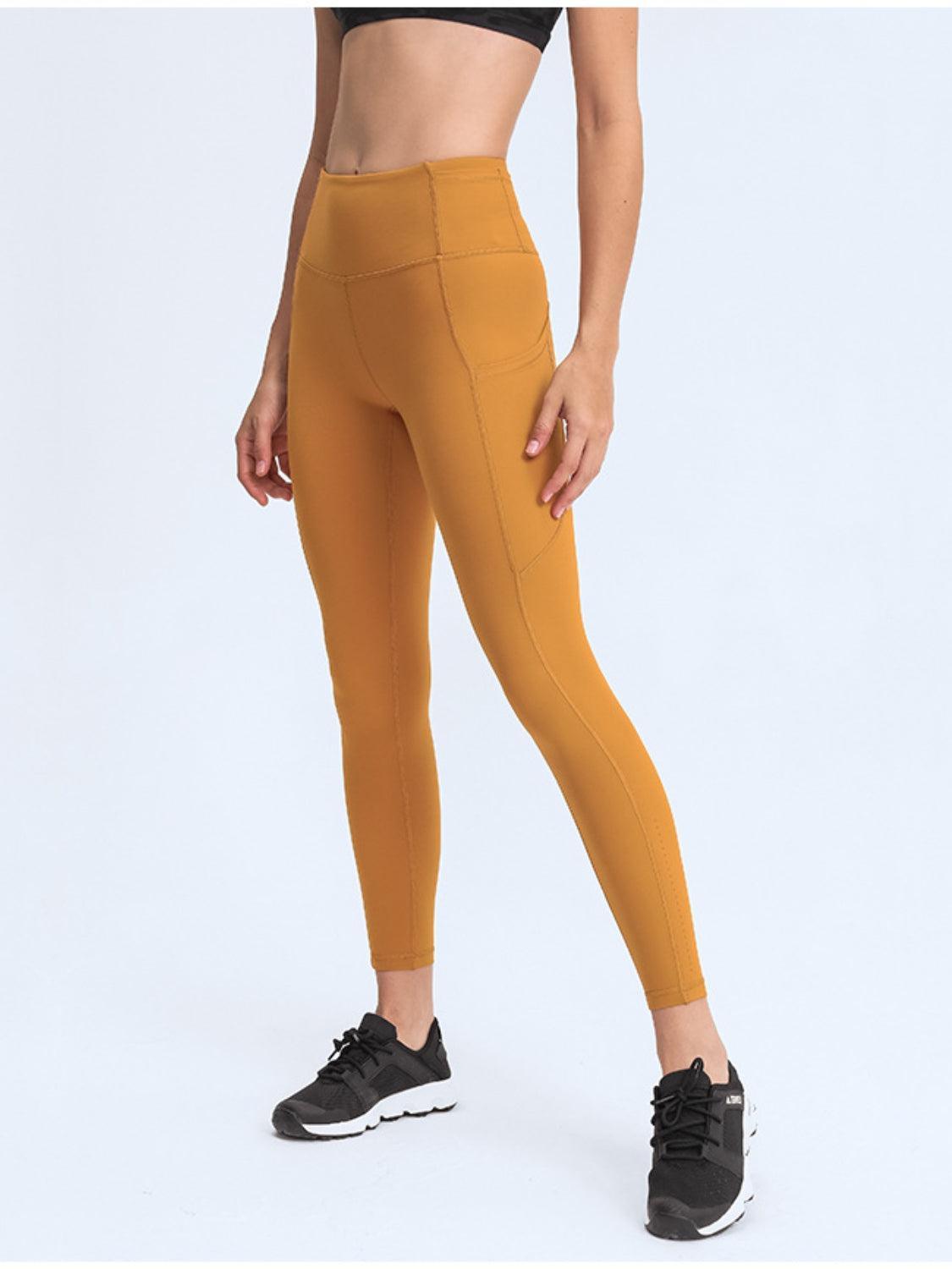 a woman in a black top and yellow leggings