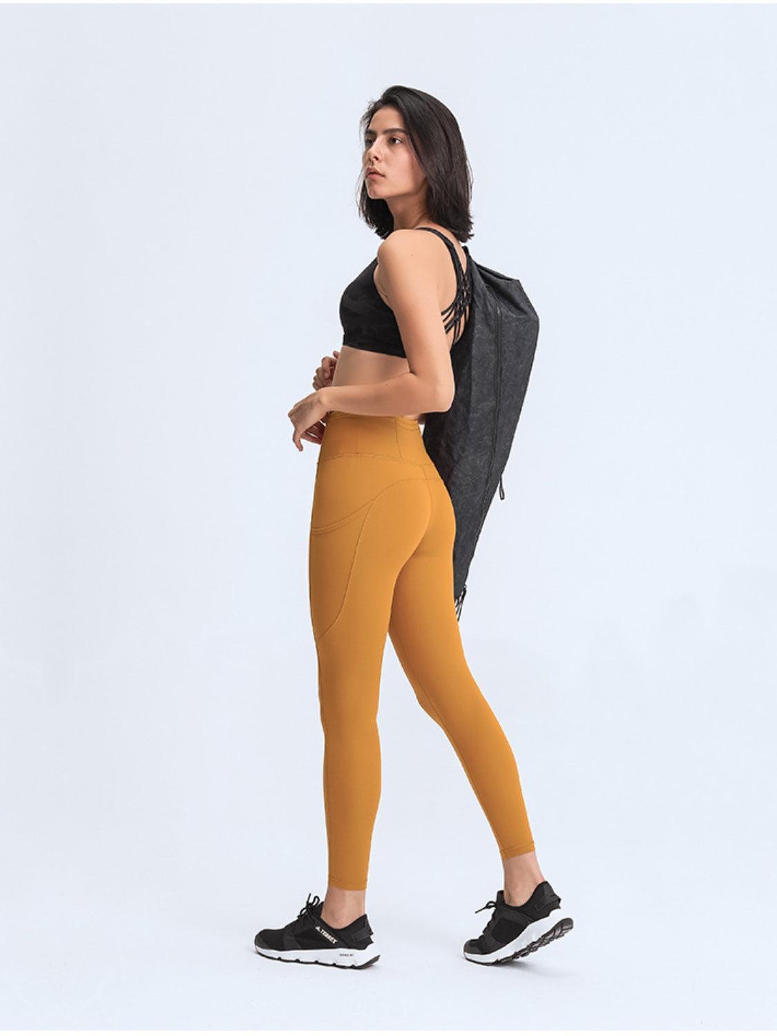 a woman in a black top and yellow leggings