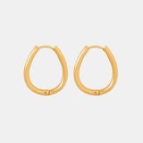 a pair of gold hoop earrings on a white background