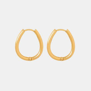 a pair of gold hoop earrings on a white background