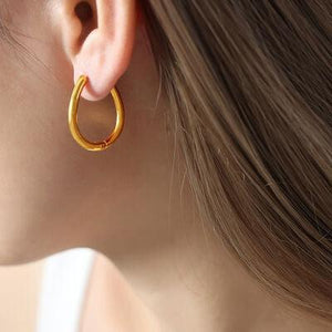 a close up of a person wearing a pair of earrings