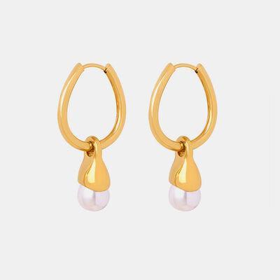 a pair of gold hoop earrings with pearls