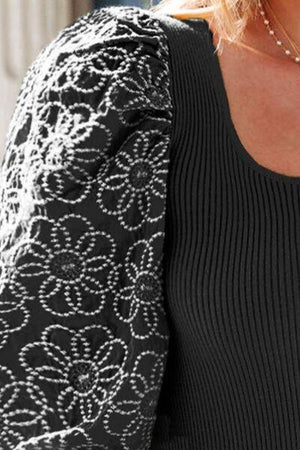 a close up of a woman wearing a black and white sweater