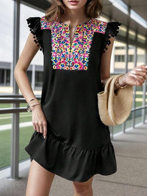 a woman in a black dress with a straw bag