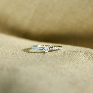 a close up of a diamond ring on a cloth