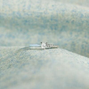 a close up of a diamond ring on a fabric