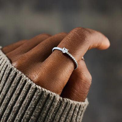 a woman's hand with a diamond ring on it