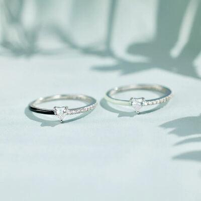 a pair of silver rings sitting on top of a table