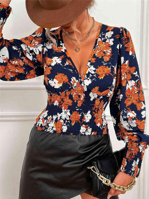 a woman wearing a floral shirt and black leather skirt