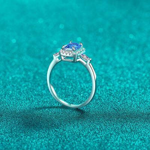 a ring with two stones on a blue background