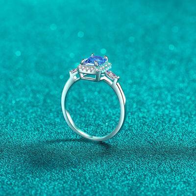 a ring with two stones on a blue background