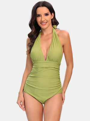 a woman in a green one piece swimsuit