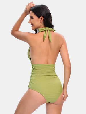 a woman in a green one piece swimsuit