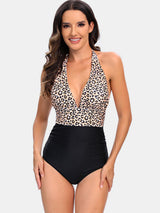 a woman in a leopard print one piece swimsuit