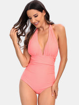 a woman in a pink one piece swimsuit