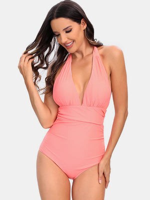 a woman in a pink one piece swimsuit