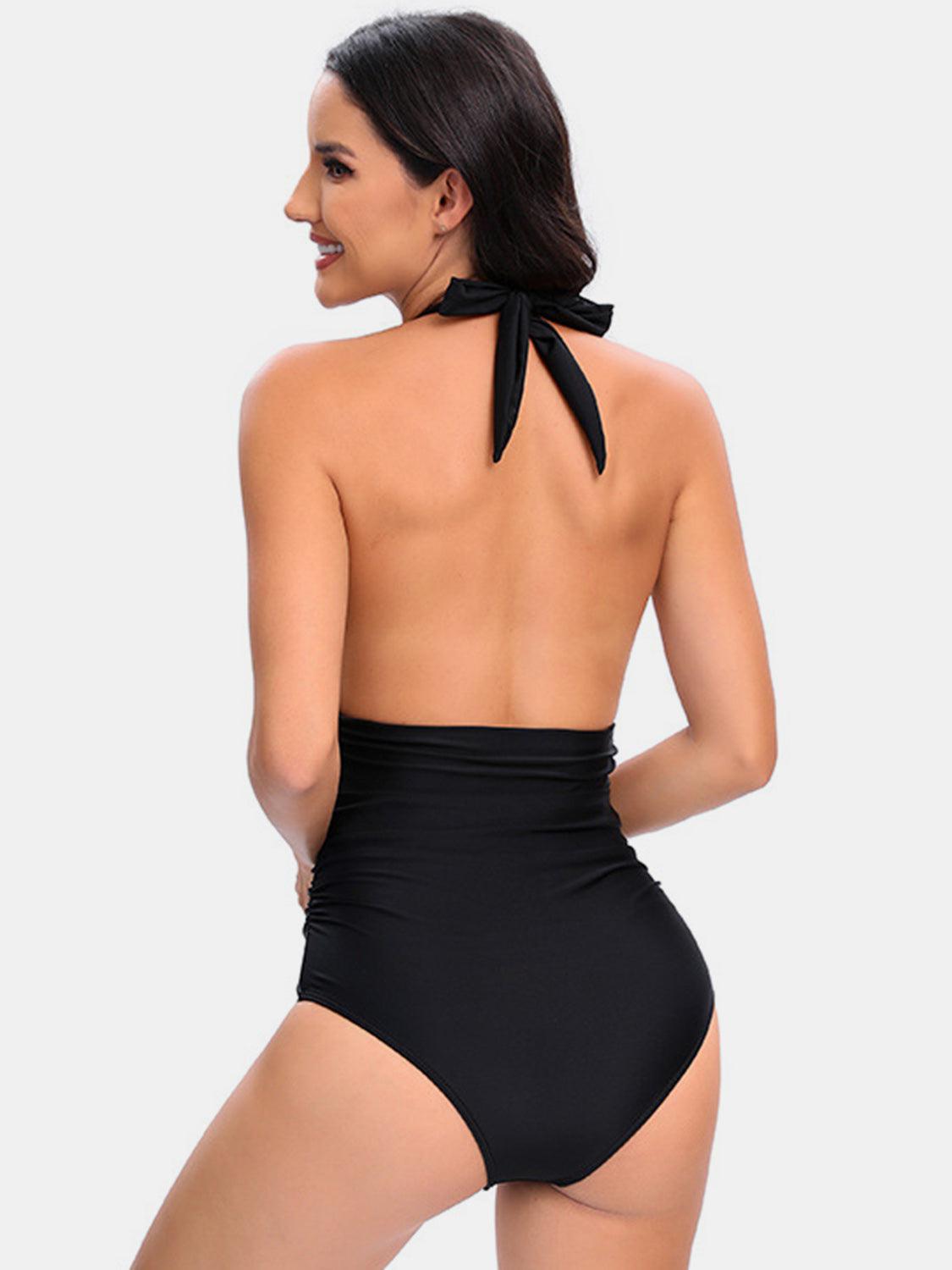 a woman in a black one piece swimsuit