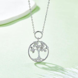 a silver tree of life pendant on a chain