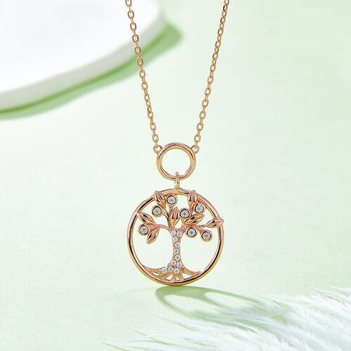 a gold necklace with a tree of life pendant