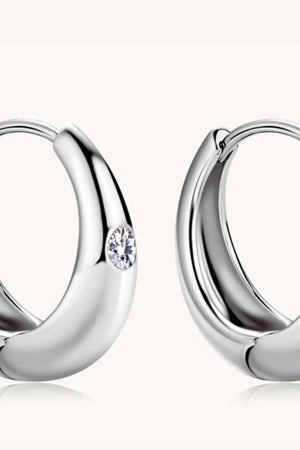a pair of silver hoop earrings with a diamond